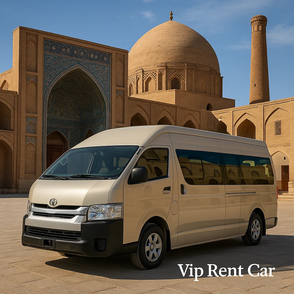 مینی‌بوس تویوتا هایس بژ در کنار مسجد تاریخی و معماری ایرانی بیرجند